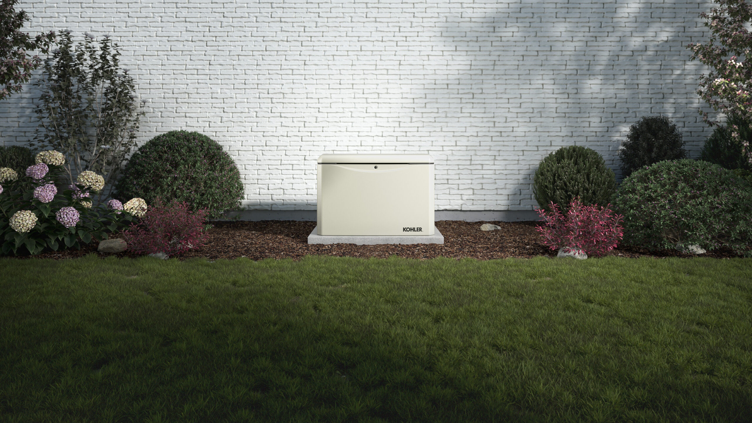 Kohler generator installed in a neatly manicured yard, close to the house