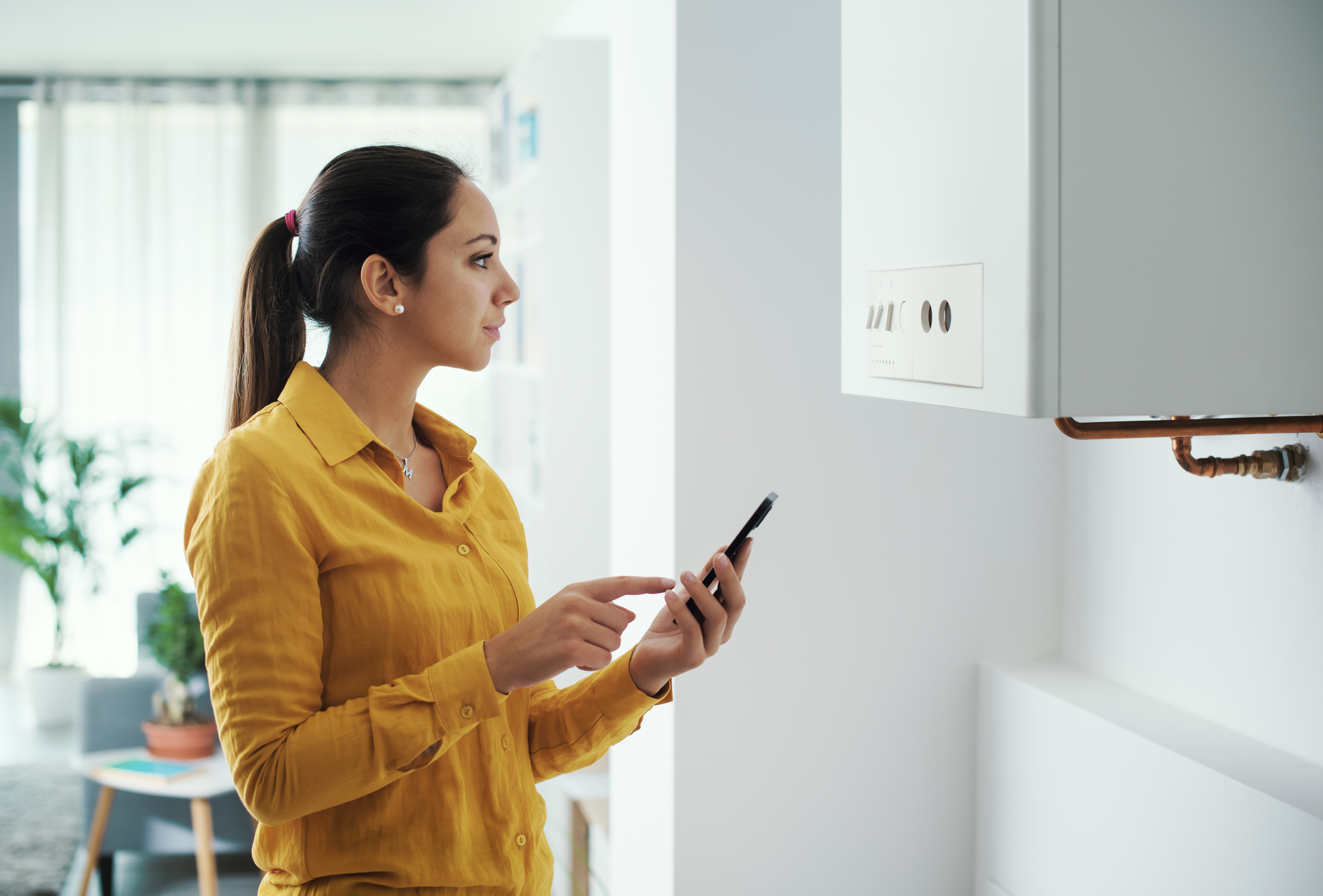 Women listening to noises coming from a boiler