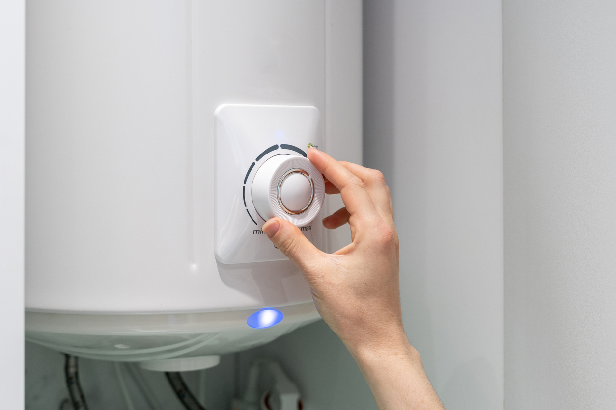 Woman adjusting setting on boiler