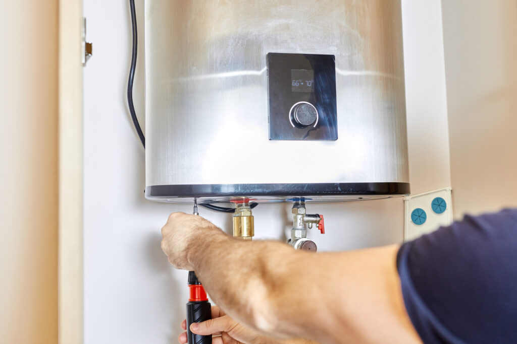 Technician repairing residential water heater